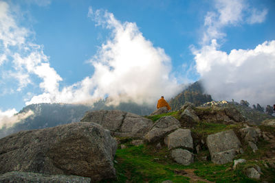 Rear view of a monk on rock landscape