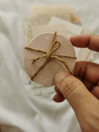 Cropped hand of person holding cookies