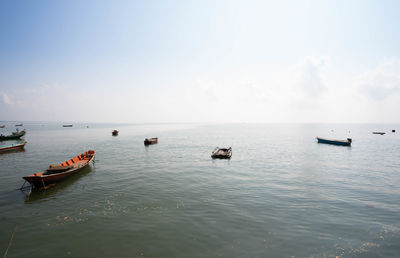 Boats in sea against sky