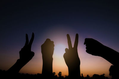 Silhouette people against sky during sunset