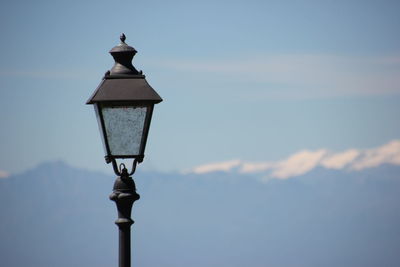 High section of lamp post against sky