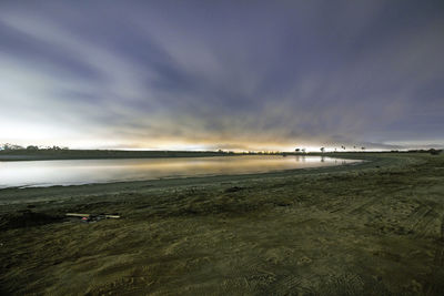 Scenic view of beach against sky during sunset