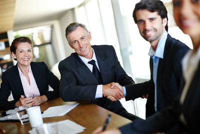 Businessmen shaking hands in office