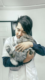 Man embracing rabbit