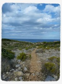 Scenic view of sea against cloudy sky