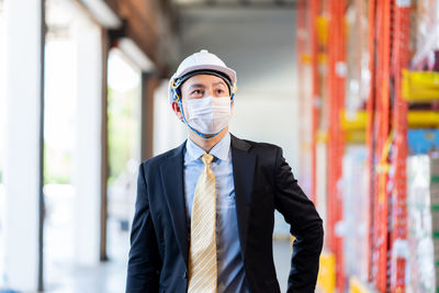 Worker wearing hardhat and mask