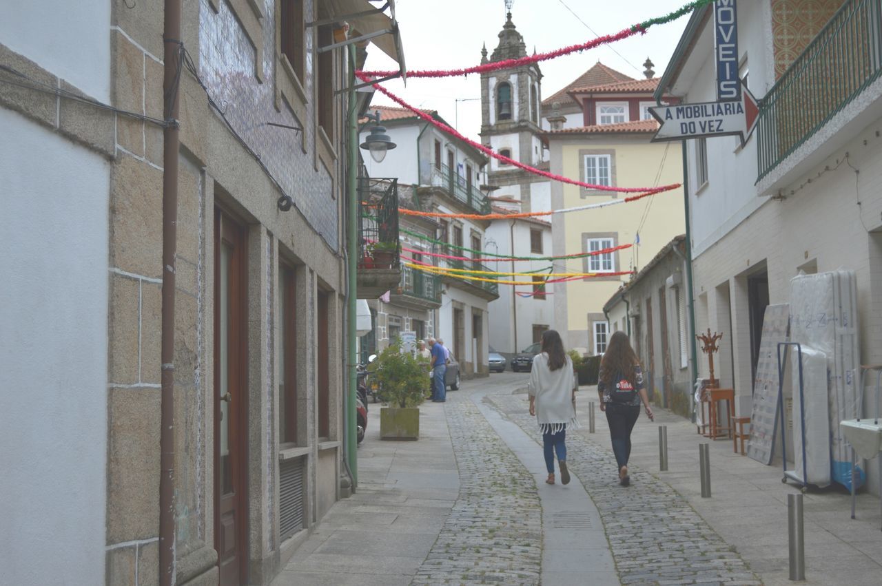 building exterior, architecture, built structure, walking, street, the way forward, city, men, building, person, residential building, residential structure, city life, alley, lifestyles, day, incidental people, outdoors, footpath