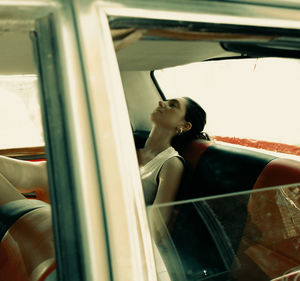 Woman sitting in car window