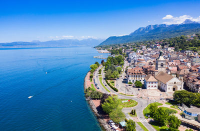 High angle view of townscape by sea against sky