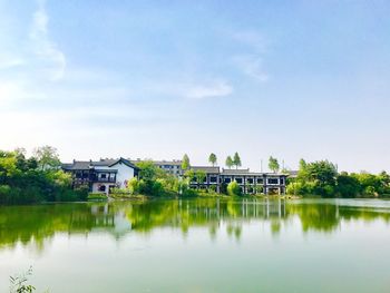 Scenic view of lake by building against sky