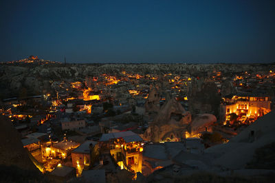 High angle view of illuminated buildings against sky at night