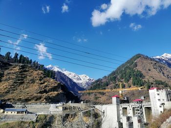 Panoramic shot of buildings and mountains against sky