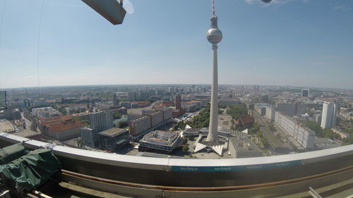 Aerial view of buildings in city against clear sky