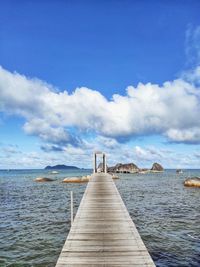 Bridge over the ocean under the cloudy blue sky