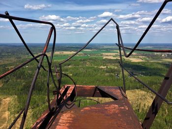 Broken railing against green landscape