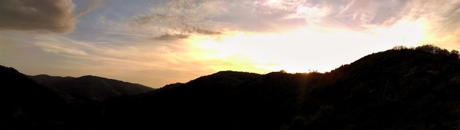 Scenic view of mountains against sky at sunset