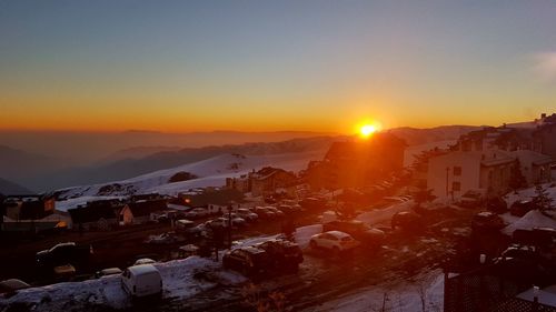 Aerial view of townscape against sky during sunset