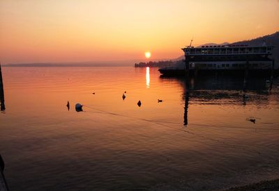 Scenic view of sea against orange sky