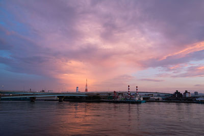 Pier over sea against sky at sunset