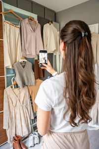 Rear view of woman using mobile phone