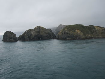 Scenic view of sea and rocks against sky