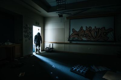 Rear view of people standing in corridor