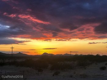 Scenic view of landscape against orange sky