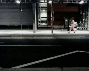 View of illuminated road at night