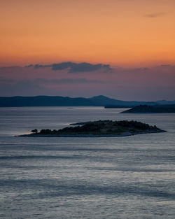 Scenic view of sea against orange sky