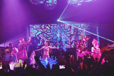 People enjoying concert at night