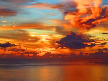 Scenic view of dramatic sky over sea during sunset