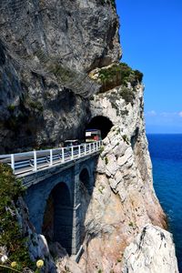 Arch bridge over sea against sky