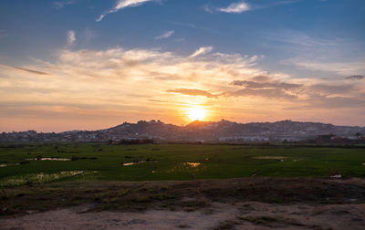Scenic view of field against sky during sunset