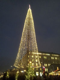 Low angle view of illuminated christmas tree at night