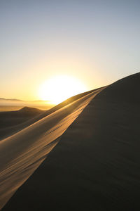 Scenic view of landscape against sky at sunset