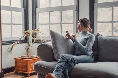 Young woman using laptop at home