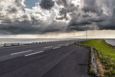 Road by sea against sky