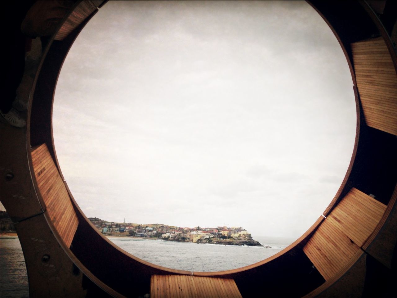 sky, built structure, circle, architecture, cloud - sky, fish-eye lens, indoors, geometric shape, building exterior, no people, day, part of, cloud, cropped, water, nature, sea, window, reflection