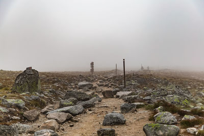 Rocks on field against sky