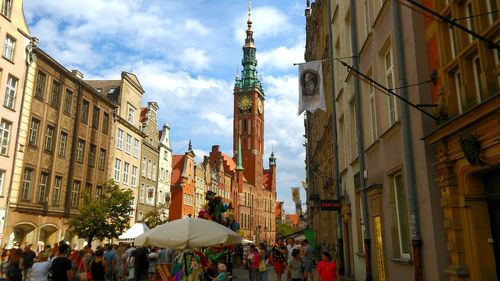 Panoramic view of people in city against sky