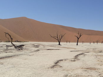 Scenic view of desert against blue sky