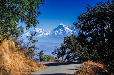 Scenic view of snowcapped mountains against blue sky