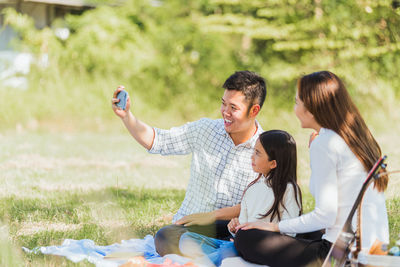 Young couple photographing on field