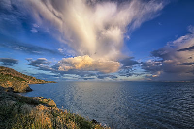 Scenic view of sea against cloudy sky