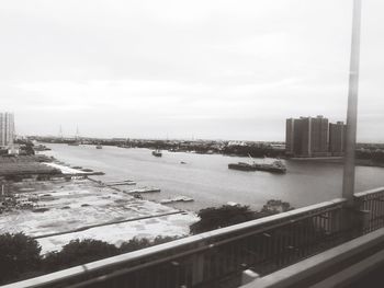 High angle view of river by buildings against sky