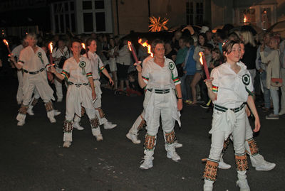 Group of people in traditional clothing at night