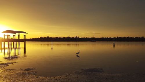 Scenic view of lake against sky during sunset