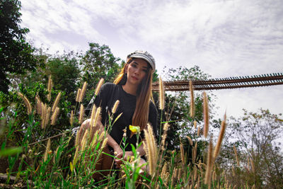 Young woman wearing sunglasses against sky