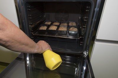 Close-up of man preparing food in kitchen at home