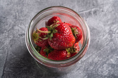 High angle view of strawberries in glass container